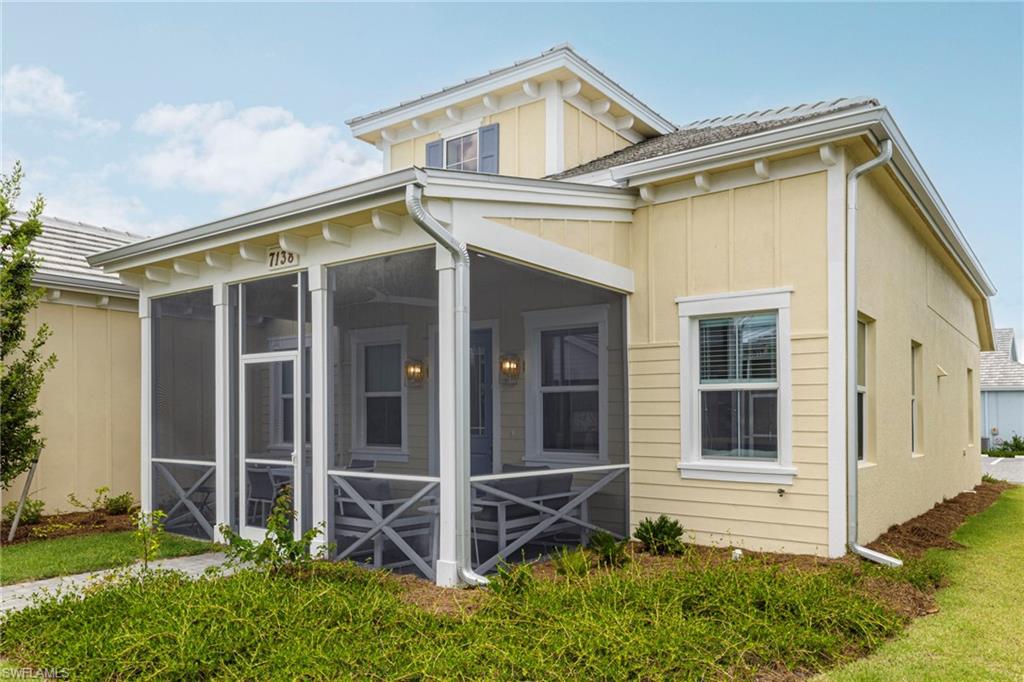 Back of house featuring a sunroom