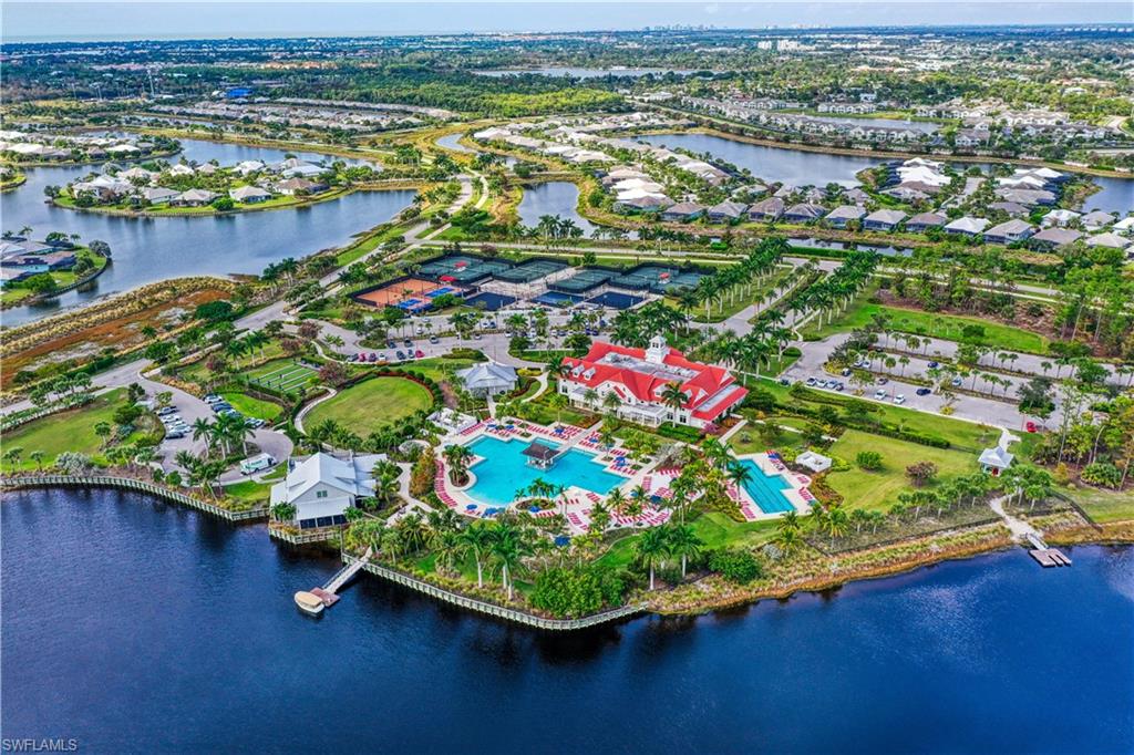 Birds eye view of property with a water view