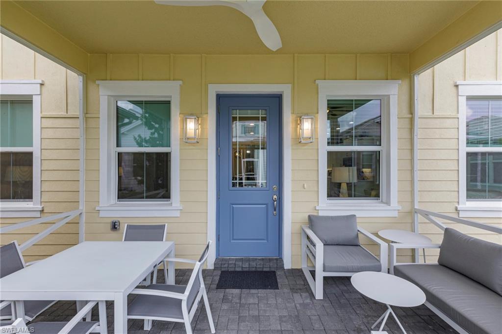 Doorway to property with ceiling fan