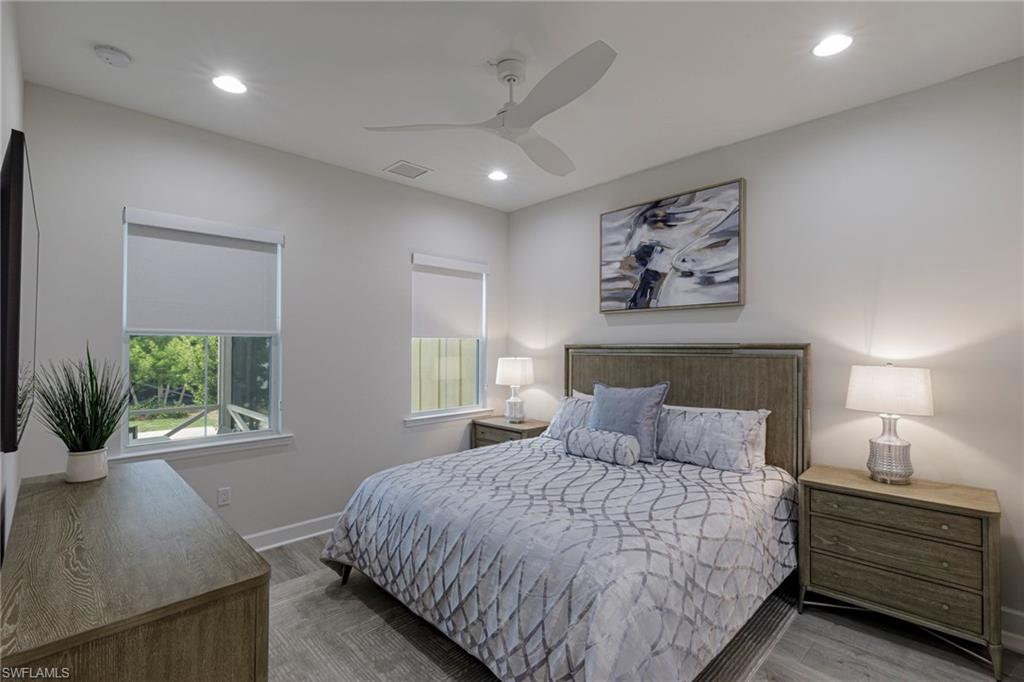 Bedroom with ceiling fan and hardwood / wood-style floors