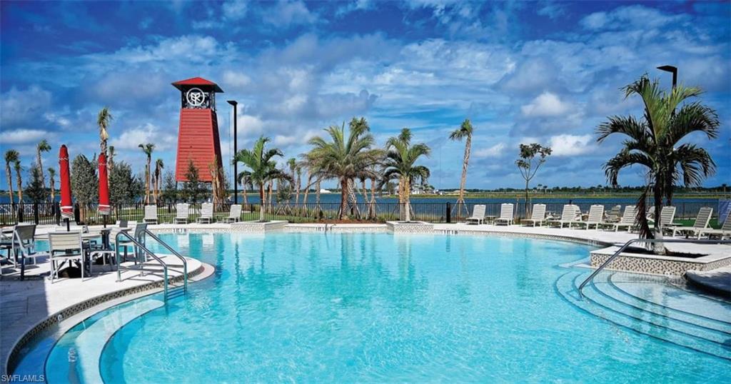 Community pool featuring a patio area and a water view