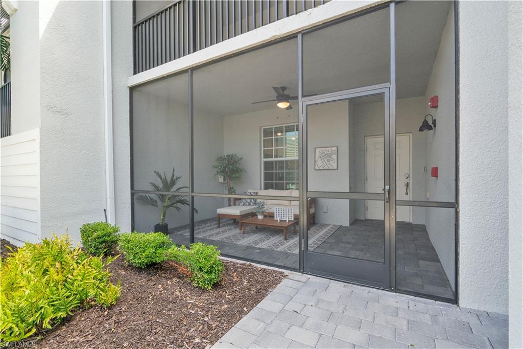 View of exterior entry featuring ceiling fan and stucco siding