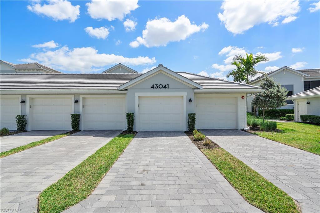 Single story home featuring a tiled roof and stucco siding