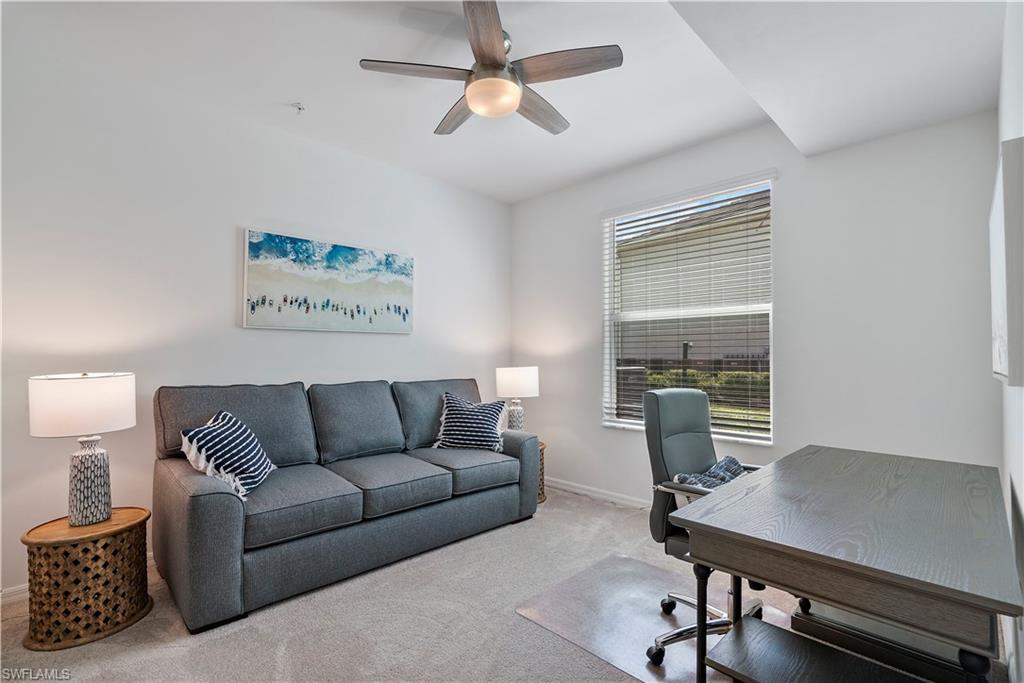 Office space with carpet and a ceiling fan