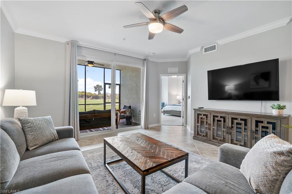 Living room with crown molding and a ceiling fan