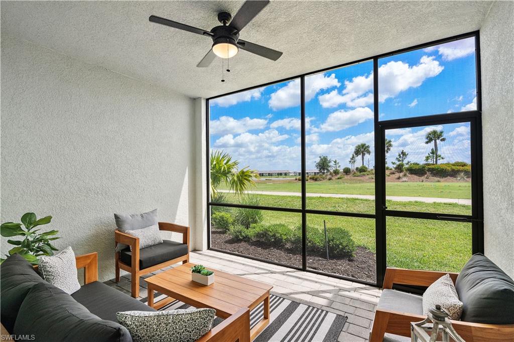 Sunroom featuring an outdoor living space and a ceiling fan