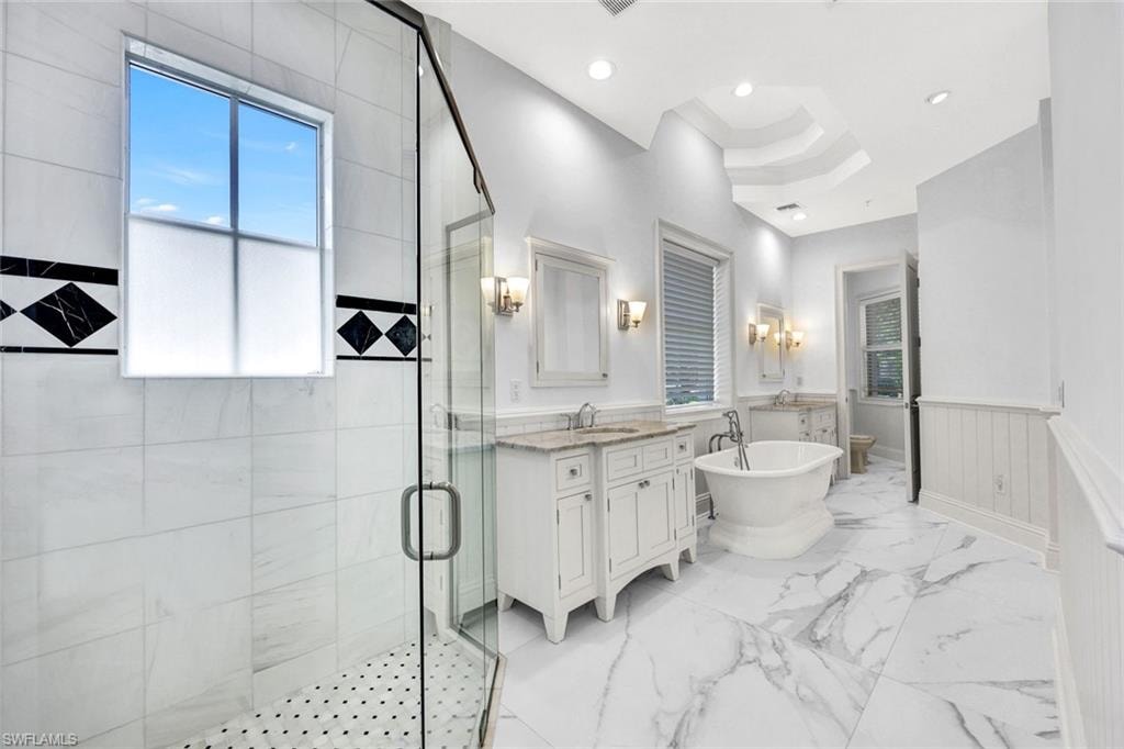 Primary bath-room with walk in shower, soaking tub and 2 vanities.