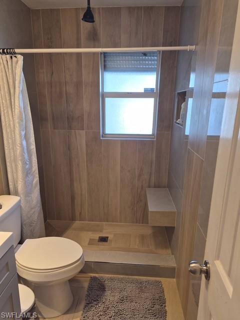 Full bathroom featuring a shower stall, vanity, and tile patterned floors