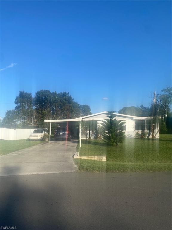 View of community featuring driveway and a carport