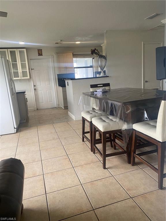 Dining space with light tile patterned floors