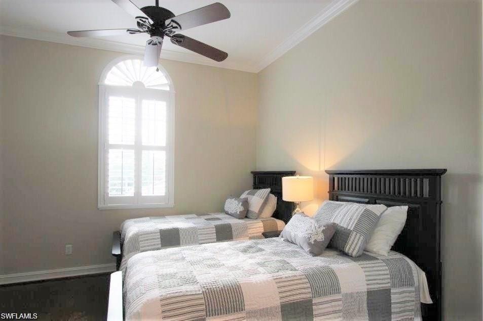Bedroom featuring crown molding and a ceiling fan