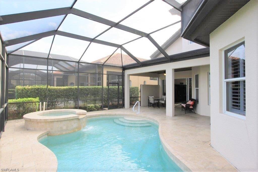 View of pool with a sunroom, a patio, a pool with connected hot tub, and a lanai