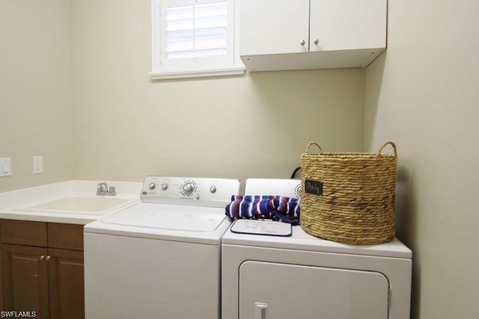 Washroom with cabinet space and independent washer and dryer