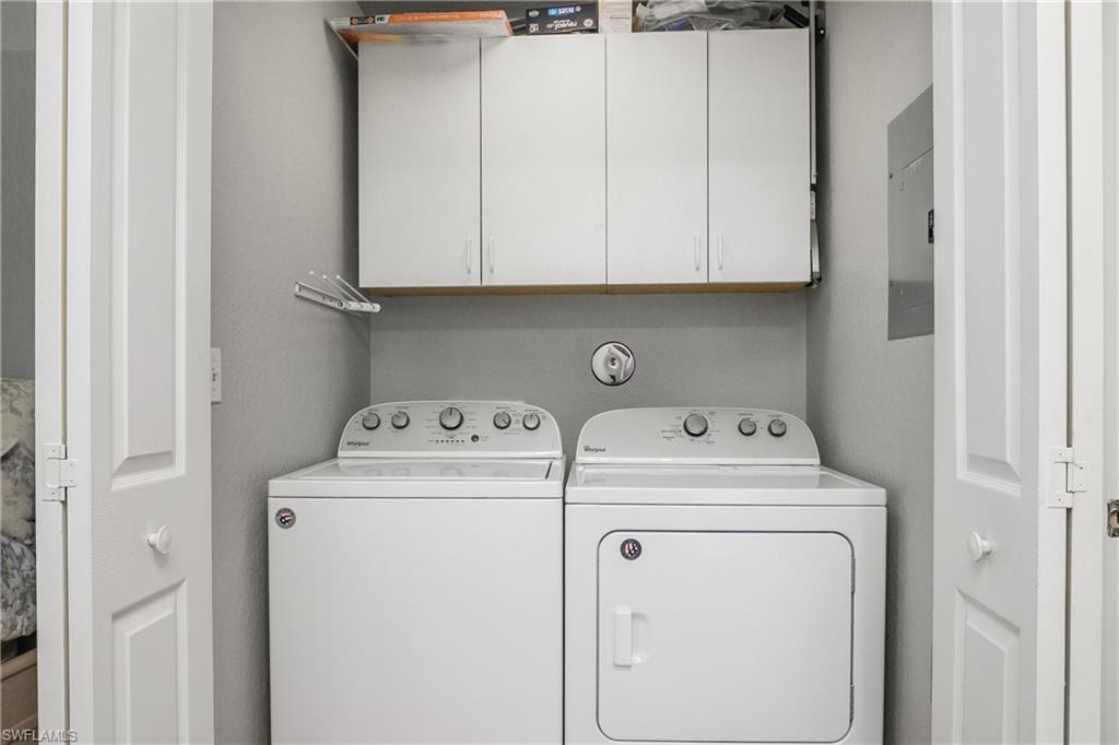 Laundry room featuring washing machine and clothes dryer and electric panel
