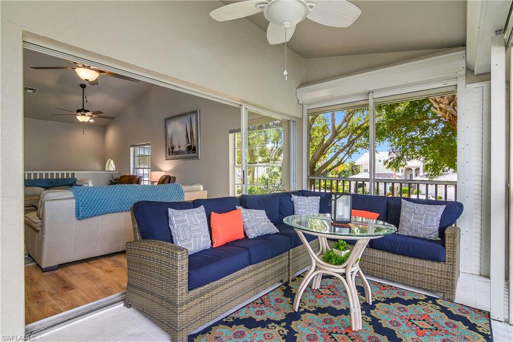 Living room with vaulted ceiling, ceiling fan, and a sunroom