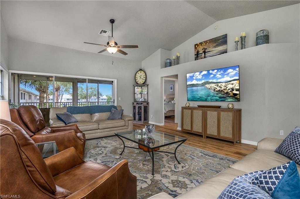 Living area featuring wood finished floors, a ceiling fan, and high vaulted ceiling