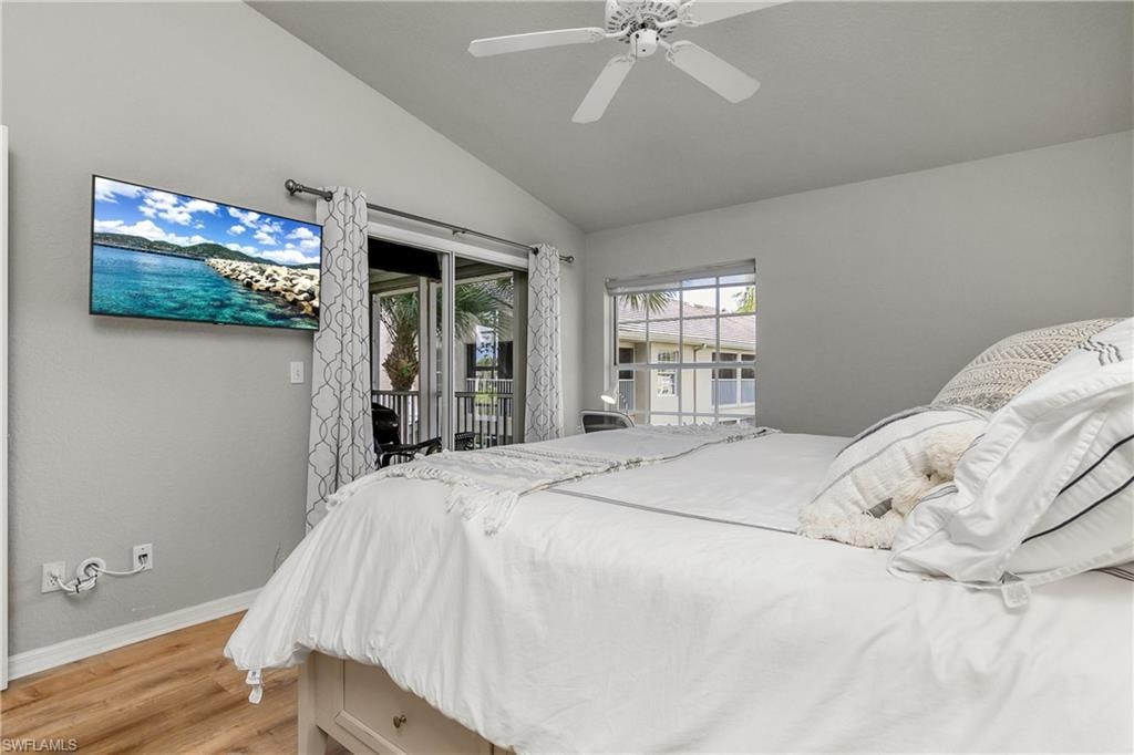 Bedroom with light wood-type flooring, access to outside, lofted ceiling, and ceiling fan