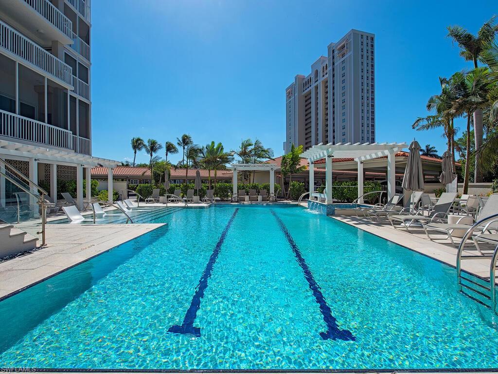 Community pool with a pergola and a patio area