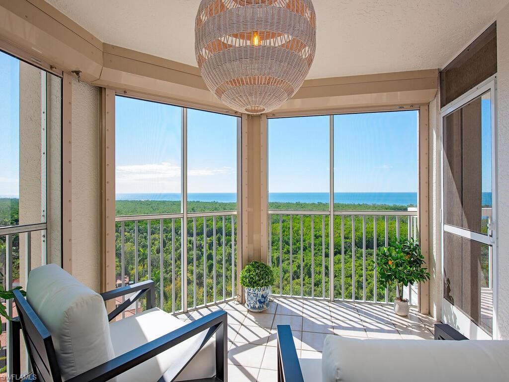 Sunroom featuring a water view