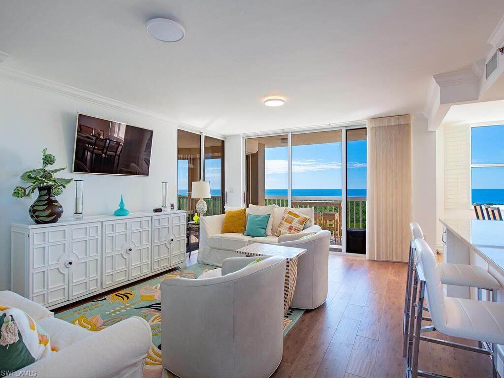 Living area with expansive windows and wood finished floors