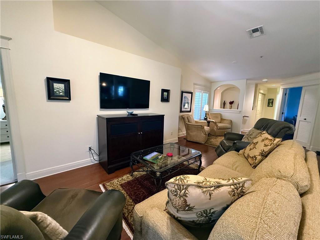 Living room featuring wood finished floors and lofted ceiling