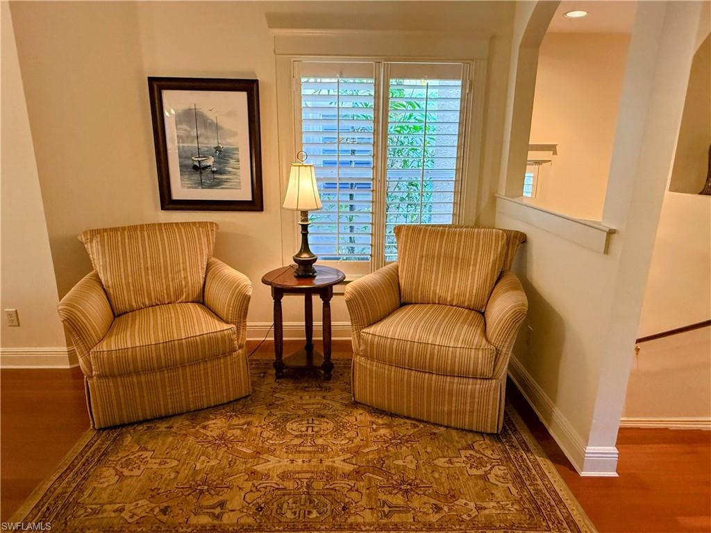 Living area with baseboards and wood finished floors