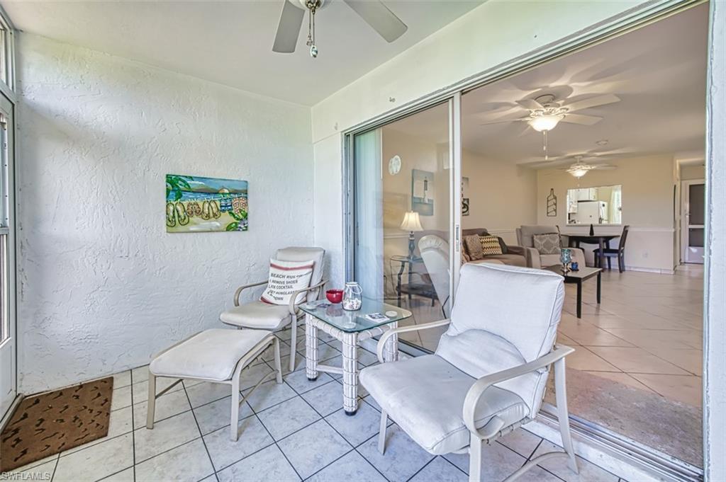 Sunroom featuring a ceiling fan and glass