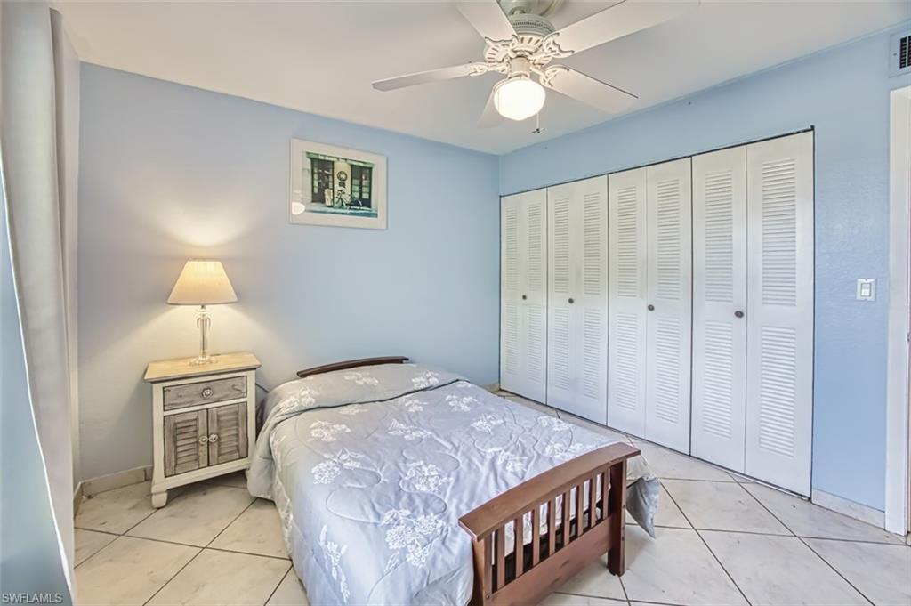 Tiled bedroom featuring a closet and ceiling fan