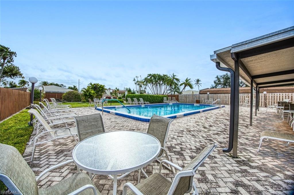 Community pool featuring a patio and a fenced backyard