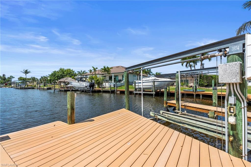 Dock area with boat lift and a water view