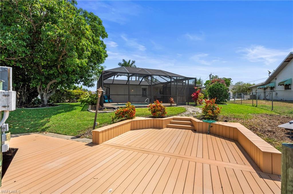 Wooden deck with glass enclosure and a sunroom