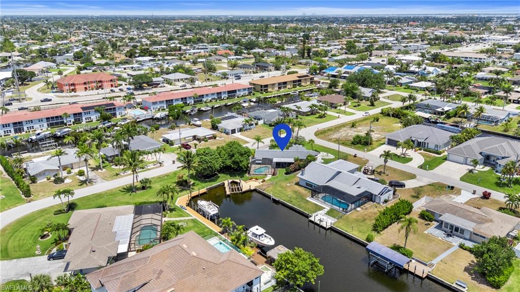 Aerial view of residential area featuring a large body of water