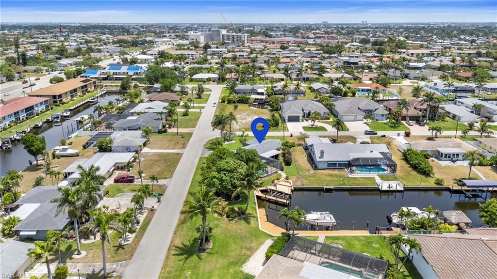 Aerial view of residential area featuring a nearby body of water