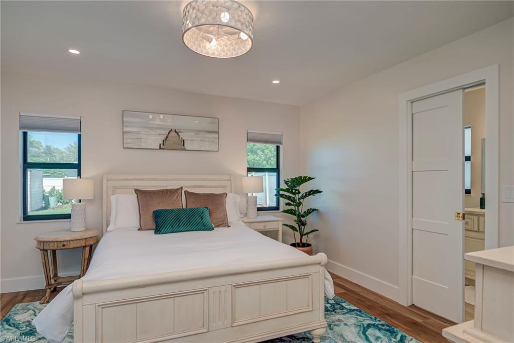 Bedroom with wood finished floors and recessed lighting
