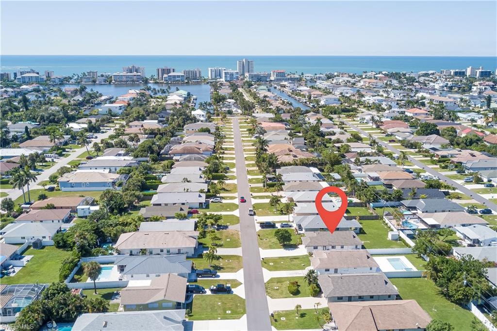 Aerial perspective of suburban area with a nearby body of water