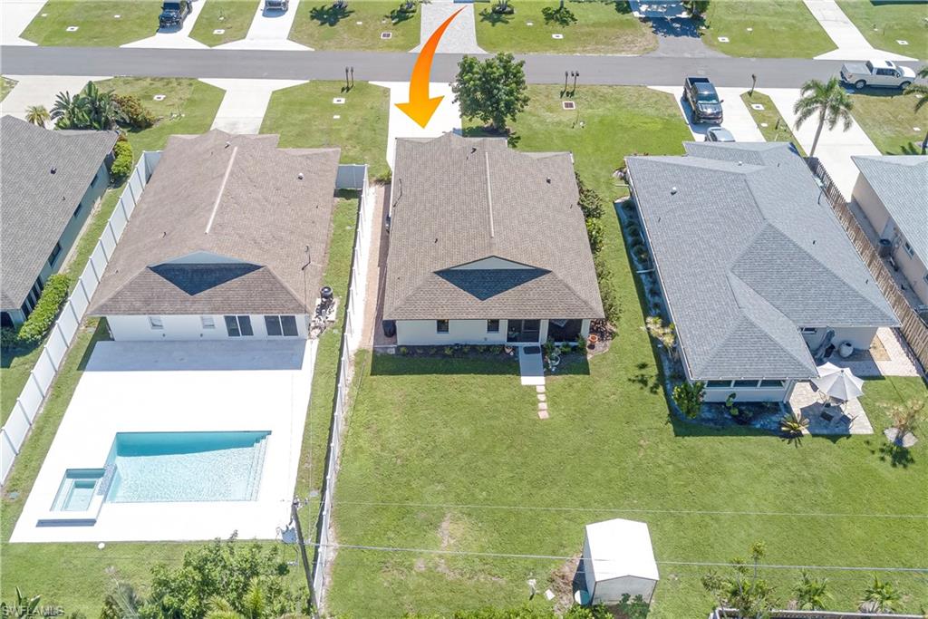 Aerial view of residential area featuring a pool