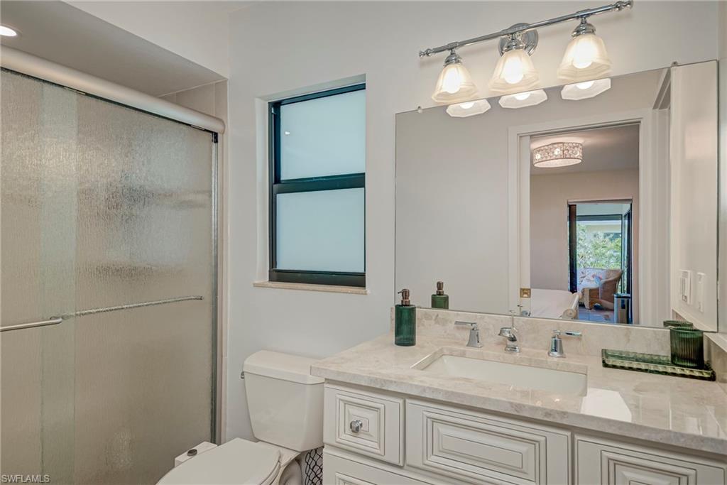 Ensuite bathroom featuring vanity and a stall shower