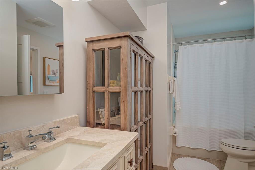 Full bath with vanity, shower / bathtub combination with curtain, and recessed lighting