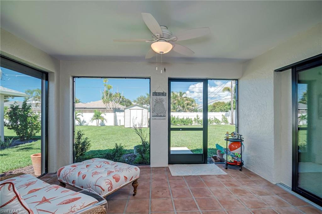 Sunroom featuring a ceiling fan