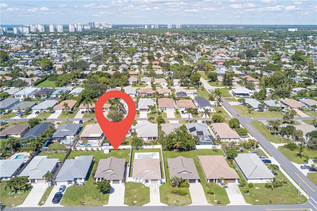 Aerial view of property's location with nearby suburban area