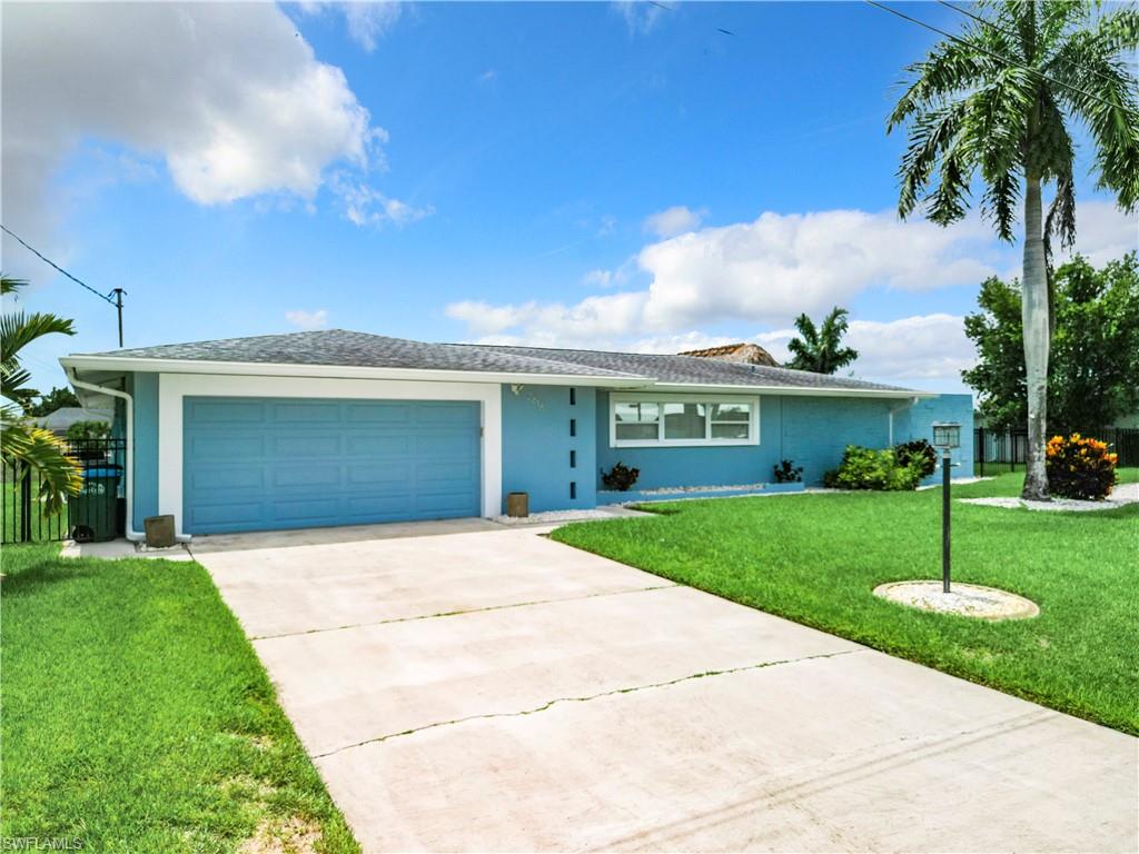 Ranch-style house with stucco siding, concrete driveway, and a garage