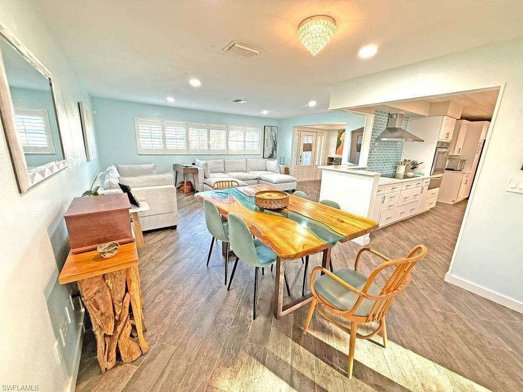 Dining room featuring light wood-style flooring and recessed lighting
