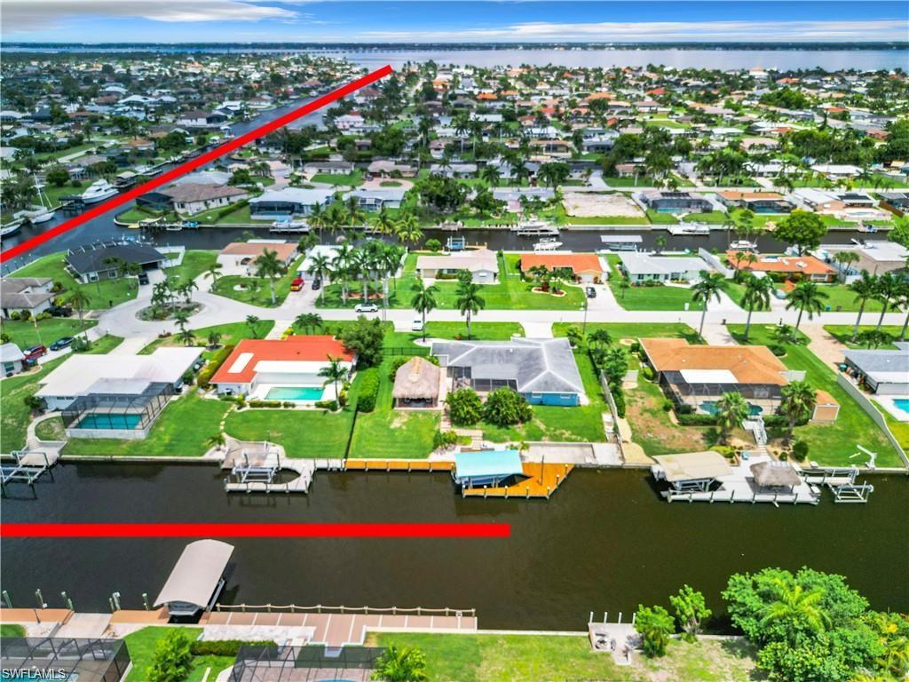 Aerial overview of property's location featuring a nearby body of water and nearby suburban area