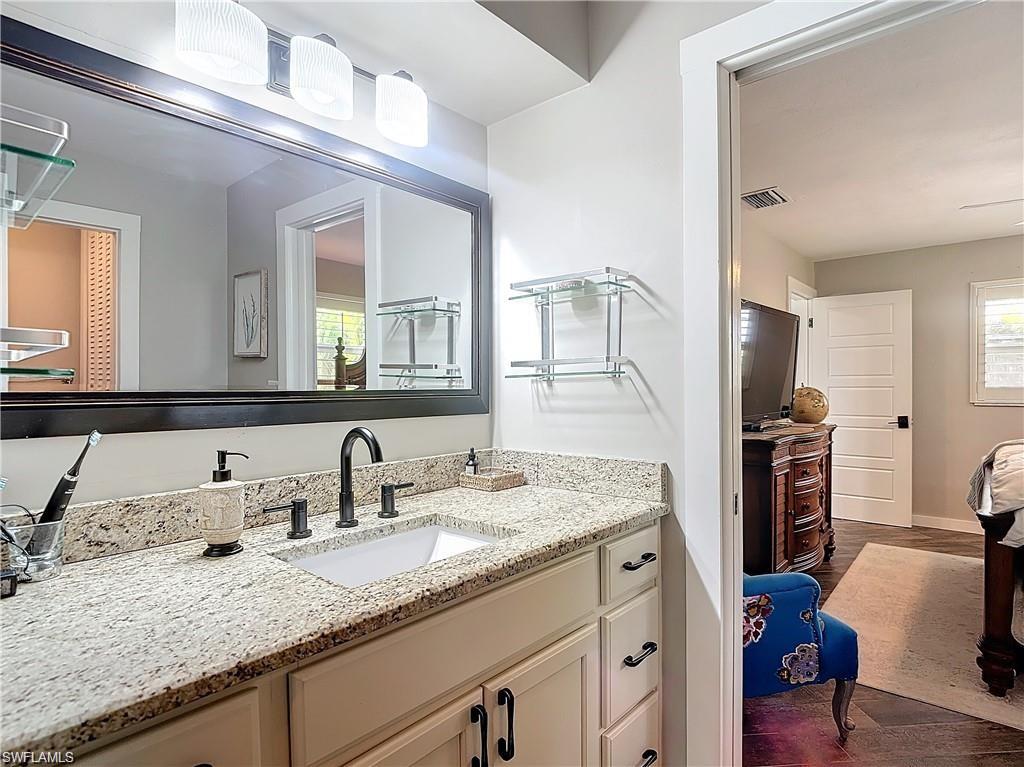 Bathroom featuring dark wood finished floors and vanity