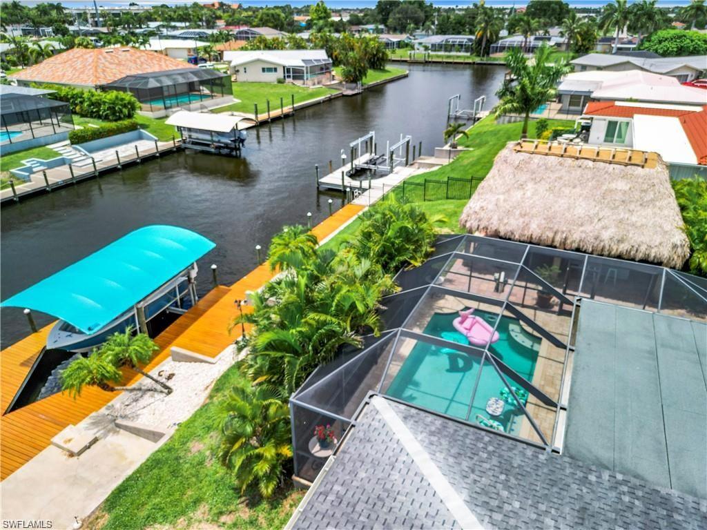 Aerial view of residential area with a large body of water and a pool