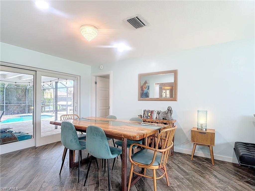 Dining space featuring dark wood-style flooring