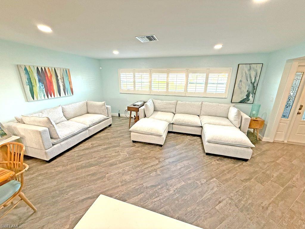 Living room featuring recessed lighting, healthy amount of natural light, and light wood-type flooring