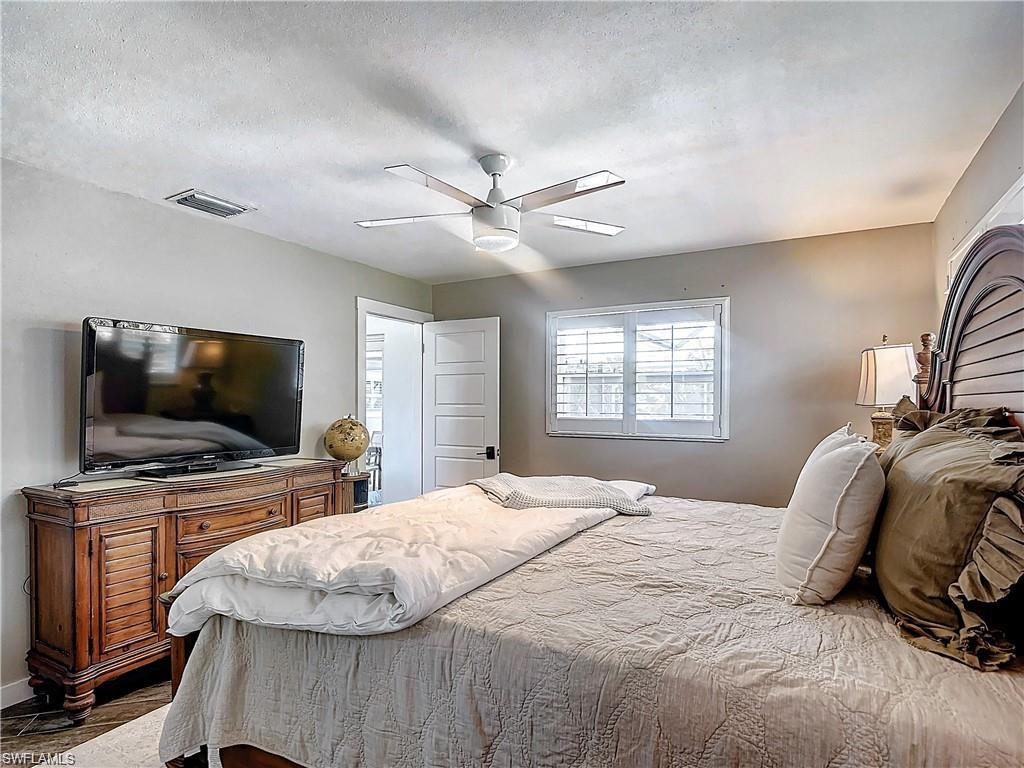 Bedroom featuring a textured ceiling and ceiling fan