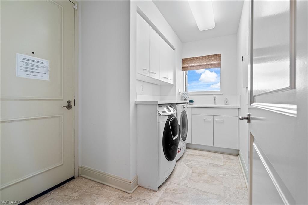 Kitchen featuring brown cabinets, ornamental molding, hanging light fixtures, stainless steel built in refrigerator, and light marble finish floors