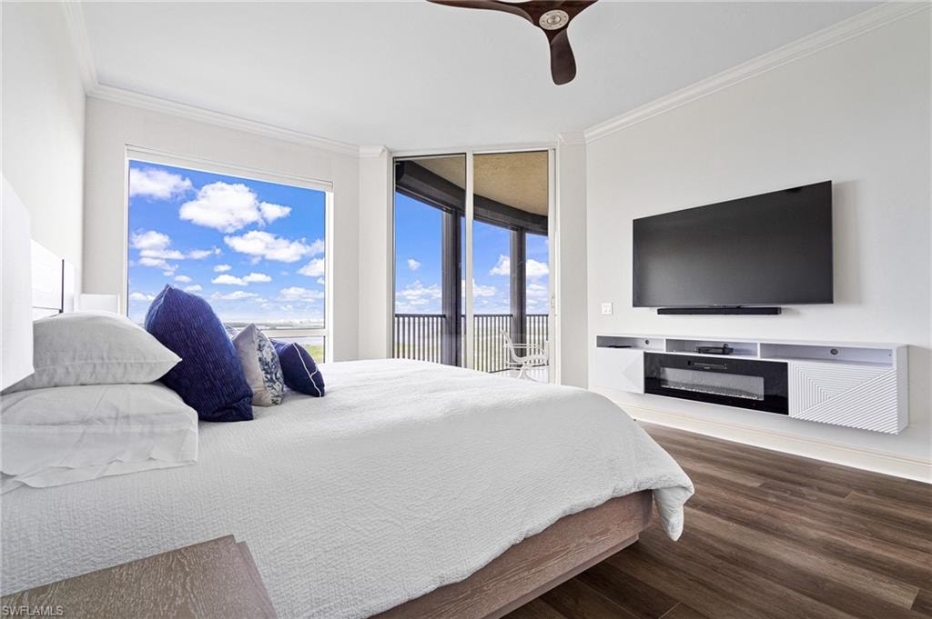 Bedroom featuring ornamental molding, dark wood-style floors, ceiling fan, and access to outside